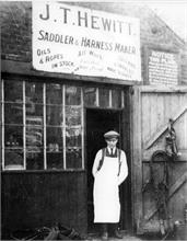 George Turner outside John Hewitt's Saddlery on Church Plain, Vicarage Street, North Walsham
