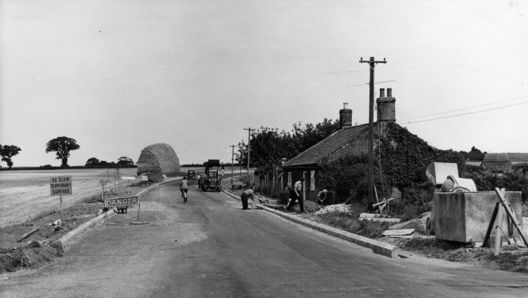 Photograph. Norwich Road roadworks at Monument Cottage (North Walsham Archive).